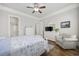 Comfortable bedroom with ceiling fan, dresser, and a view to an attached bathroom at 350 Saint Julian Ln., Myrtle Beach, SC 29579