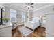 This bedroom features a wooden floor, neutral walls, white furniture, and plenty of natural light at 350 Saint Julian Ln., Myrtle Beach, SC 29579