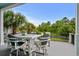 Covered deck with outdoor seating, a view of the backyard, and tropical landscaping at 350 Saint Julian Ln., Myrtle Beach, SC 29579