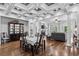 Well-lit dining area with hardwood floors that flows into a living area with fireplace and coffered ceilings at 350 Saint Julian Ln., Myrtle Beach, SC 29579