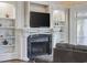 Cozy living room area featuring a fireplace flanked by built-in shelving and large windows at 350 Saint Julian Ln., Myrtle Beach, SC 29579