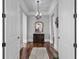 Elegant hallway with hardwood floors, chandelier, console table and decorative mirror at 350 Saint Julian Ln., Myrtle Beach, SC 29579