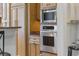 Modern kitchen with stainless steel oven and microwave, plus wooden cabinetry at 350 Saint Julian Ln., Myrtle Beach, SC 29579