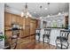 Spacious kitchen featuring wooden cabinets and granite countertops with bar seating at 350 Saint Julian Ln., Myrtle Beach, SC 29579
