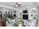 Comfortable living room with a fireplace, ceiling fan, hardwood floors, and integrated shelving at 350 Saint Julian Ln., Myrtle Beach, SC 29579