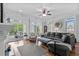 Living room with sliding doors to deck, ceiling fan, hardwood floors, and a large sectional at 350 Saint Julian Ln., Myrtle Beach, SC 29579