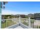 A neighborhood view from the balcony showcasing lush greenery and blue sky at 350 Saint Julian Ln., Myrtle Beach, SC 29579