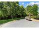 Landscaped backyard with lush greenery, black fence, and a well-maintained lawn at 3647 Diamond Stars Way, Little River, SC 29566