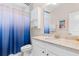 Bathroom with granite counters, a white vanity, a wall mirror, and a blue decorative shower curtain at 3647 Diamond Stars Way, Little River, SC 29566