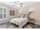 Charming bedroom features a ceiling fan, a cozy bed with patterned linens, and stylish decor at 3647 Diamond Stars Way, Little River, SC 29566