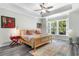 Bright bedroom with tray ceiling, large windows, wooden bed frame and stylish decor create a serene retreat at 3647 Diamond Stars Way, Little River, SC 29566