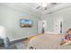 Relaxing bedroom with TV, plush bed, tray ceilings, and soft lighting, offering a comfortable and inviting atmosphere at 3647 Diamond Stars Way, Little River, SC 29566