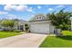 Inviting exterior of a house with a two-car garage, green lawn, and mature landscaping at 3647 Diamond Stars Way, Little River, SC 29566