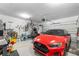 Well-lit garage featuring a sleek red car, bike rack, and ample storage at 3647 Diamond Stars Way, Little River, SC 29566
