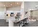 Spacious kitchen with white cabinets, granite countertops, an island, and modern stainless steel appliances at 3647 Diamond Stars Way, Little River, SC 29566