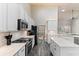Well-lit kitchen with white cabinetry, stainless appliances, and a view into the adjacent living space at 3647 Diamond Stars Way, Little River, SC 29566