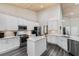 Modern kitchen with white cabinets, stainless steel appliances, and an island with granite countertops at 3647 Diamond Stars Way, Little River, SC 29566