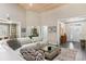 Bright living room featuring a comfortable white sofa, modern glass table, and views of the entryway and office at 3647 Diamond Stars Way, Little River, SC 29566