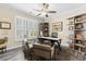 Bright office with a large window, a modern desk, shelving units, and sleek gray flooring at 3647 Diamond Stars Way, Little River, SC 29566