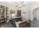 Home office space with modern desk, chairs, shelving units, and sleek gray flooring at 3647 Diamond Stars Way, Little River, SC 29566