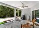 Relaxing screened-in porch with ceiling fan, bench, comfortable chairs, and a tranquil view at 3647 Diamond Stars Way, Little River, SC 29566