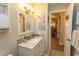 Bathroom featuring a vanity with a stylish granite countertop and a decorative mirror at 3879 Mallard Way, Little River, SC 29566