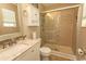 Bathroom with glass shower, tiled shower, granite vanity, and toiletry cabinet at 3879 Mallard Way, Little River, SC 29566