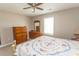 Bright bedroom featuring neutral walls, a ceiling fan, and classic wood furnishings at 3879 Mallard Way, Little River, SC 29566