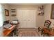 Bedroom features closet, wood-look flooring, and offers a functional home office setup at 3879 Mallard Way, Little River, SC 29566