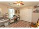 Bedroom with a wood-look floor, ceiling fan, closet, and versatile work/office space at 3879 Mallard Way, Little River, SC 29566