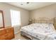 Cozy bedroom with a brass-colored bedframe, dresser, and neutral color palette at 3879 Mallard Way, Little River, SC 29566