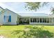 Side view of the home featuring a screened in porch and manicured lawn at 3879 Mallard Way, Little River, SC 29566