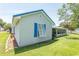 Exterior side view of home with blue shutters, screened-in porch, and green grass at 3879 Mallard Way, Little River, SC 29566