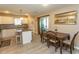 Eat-in kitchen with white cabinets, granite counters, stainless steel appliances and sliding glass door at 3879 Mallard Way, Little River, SC 29566