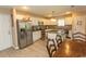 Bright kitchen with white cabinets, granite countertops, stainless steel appliances and wood floor at 3879 Mallard Way, Little River, SC 29566