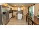 Bright kitchen with white cabinets, granite countertops, stainless steel appliances, and access to the dining area at 3879 Mallard Way, Little River, SC 29566