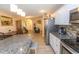 Open-concept kitchen with granite countertops, stainless steel appliances, and light wood flooring at 3879 Mallard Way, Little River, SC 29566