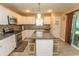 Well-lit kitchen featuring granite countertops, modern appliances, white cabinetry and island with seating at 3879 Mallard Way, Little River, SC 29566