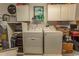 Functional laundry area with washer, dryer, and ample storage cabinets at 3879 Mallard Way, Little River, SC 29566