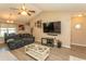 Inviting living room with wood floors, a vaulted ceiling, large TV, and comfortable seating at 3879 Mallard Way, Little River, SC 29566
