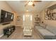 Open living room showcasing wood floors, vaulted ceiling, TV, and neutral-toned furniture at 3879 Mallard Way, Little River, SC 29566