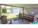Covered patio featuring wooden furniture and decor overlooking the lawn and shed at 3879 Mallard Way, Little River, SC 29566