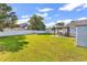 Spacious backyard featuring a well-maintained lawn, white fence, and a cozy gazebo with outdoor furniture at 3907 Stillwood Dr., Myrtle Beach, SC 29588