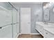 Bathroom featuring glass shower doors, a white door, and double vanity at 3907 Stillwood Dr., Myrtle Beach, SC 29588