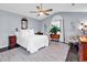 Bright bedroom features a ceiling fan, an arched window with curtain, and a comfortable chair at 3907 Stillwood Dr., Myrtle Beach, SC 29588