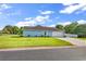 Exterior side view of the property featuring a well-kept lawn, a driveway, and an attached garage at 3907 Stillwood Dr., Myrtle Beach, SC 29588