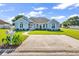 Charming light blue home with landscaped front yard, driveway, and well-maintained lawn at 3907 Stillwood Dr., Myrtle Beach, SC 29588