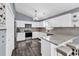 Well-lit kitchen features granite counters, stainless steel appliances, and modern white cabinetry at 3907 Stillwood Dr., Myrtle Beach, SC 29588