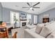 Cozy living room featuring a fireplace, TV, hardwood floors, and large windows at 3907 Stillwood Dr., Myrtle Beach, SC 29588