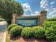 Community entrance sign with lush greenery, showcasing the neighborhood's welcoming atmosphere at 3907 Stillwood Dr., Myrtle Beach, SC 29588